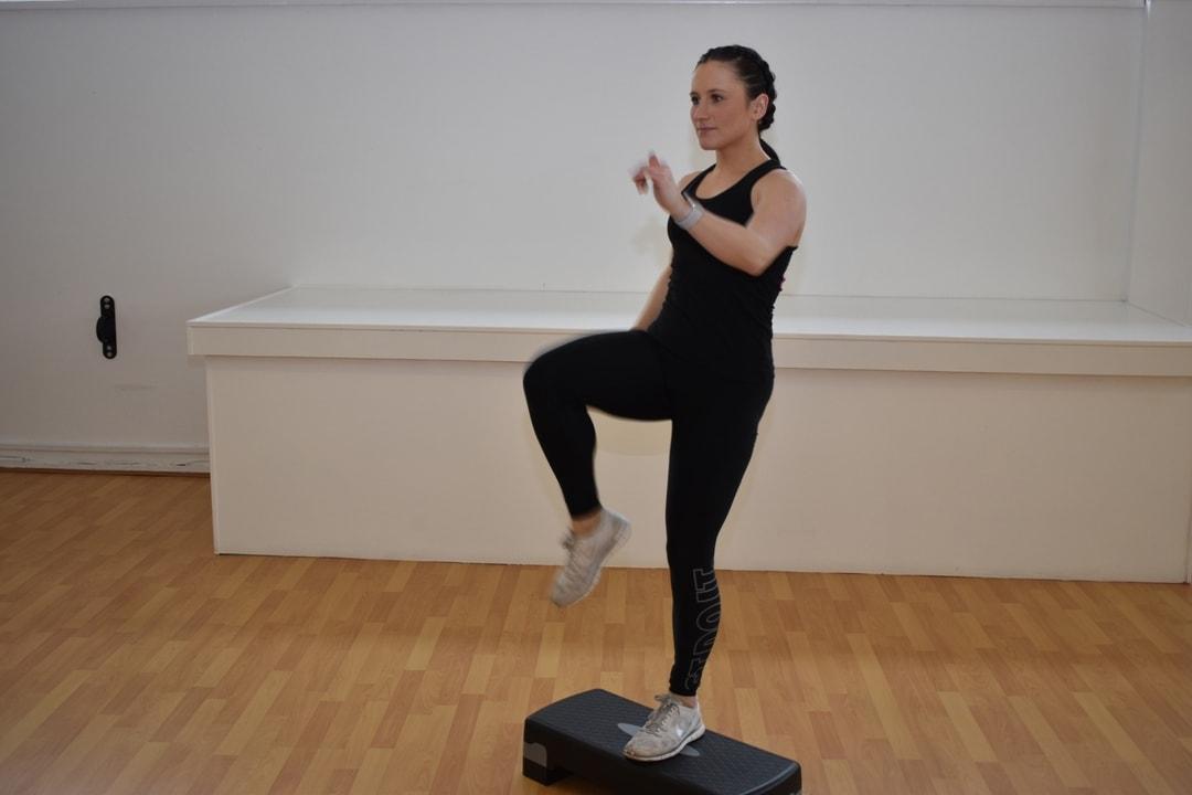 Woman using a step up platform in a dance studio