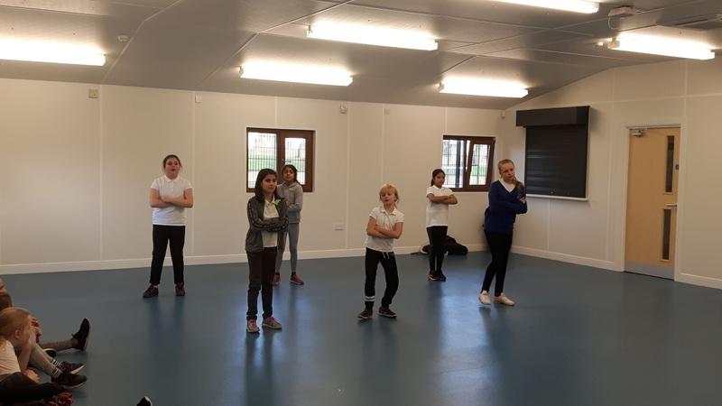 A group of people taking a dance class