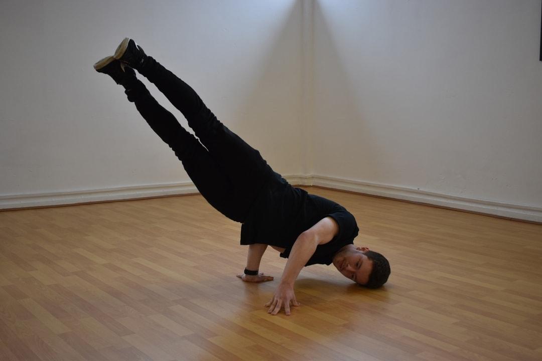 Man spinning on his head in the dance studio