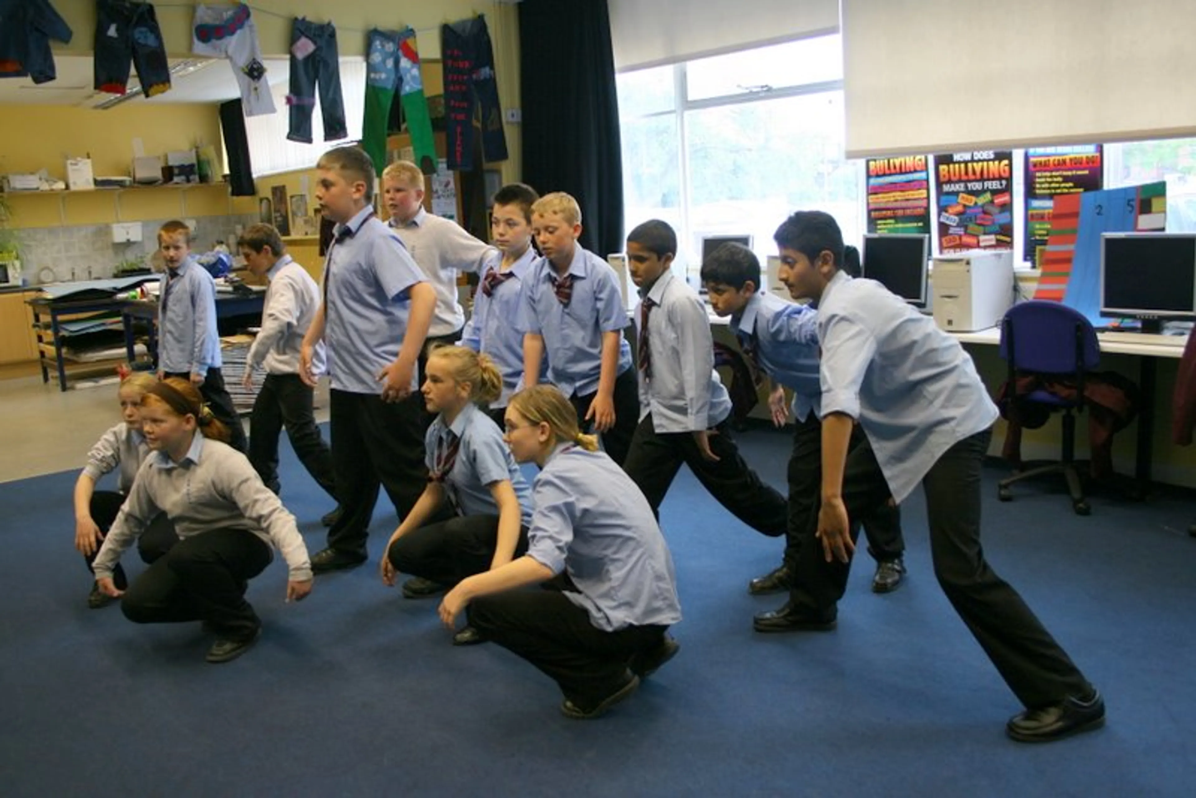 A group of kids taking a dance lesson