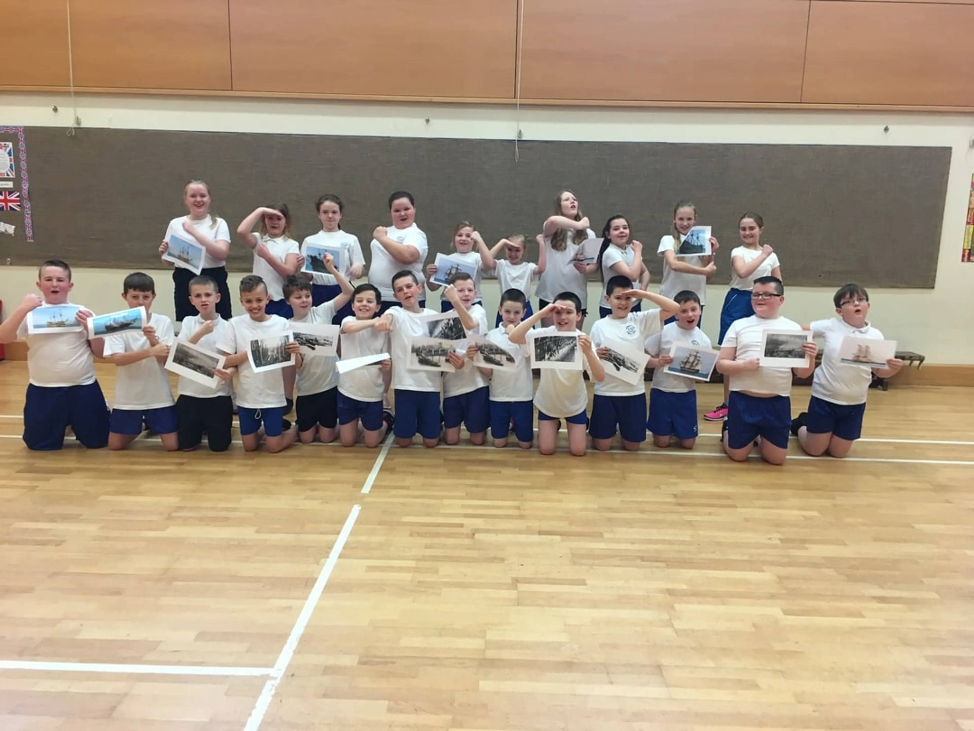 A group of kids facing the camera taking a group photo