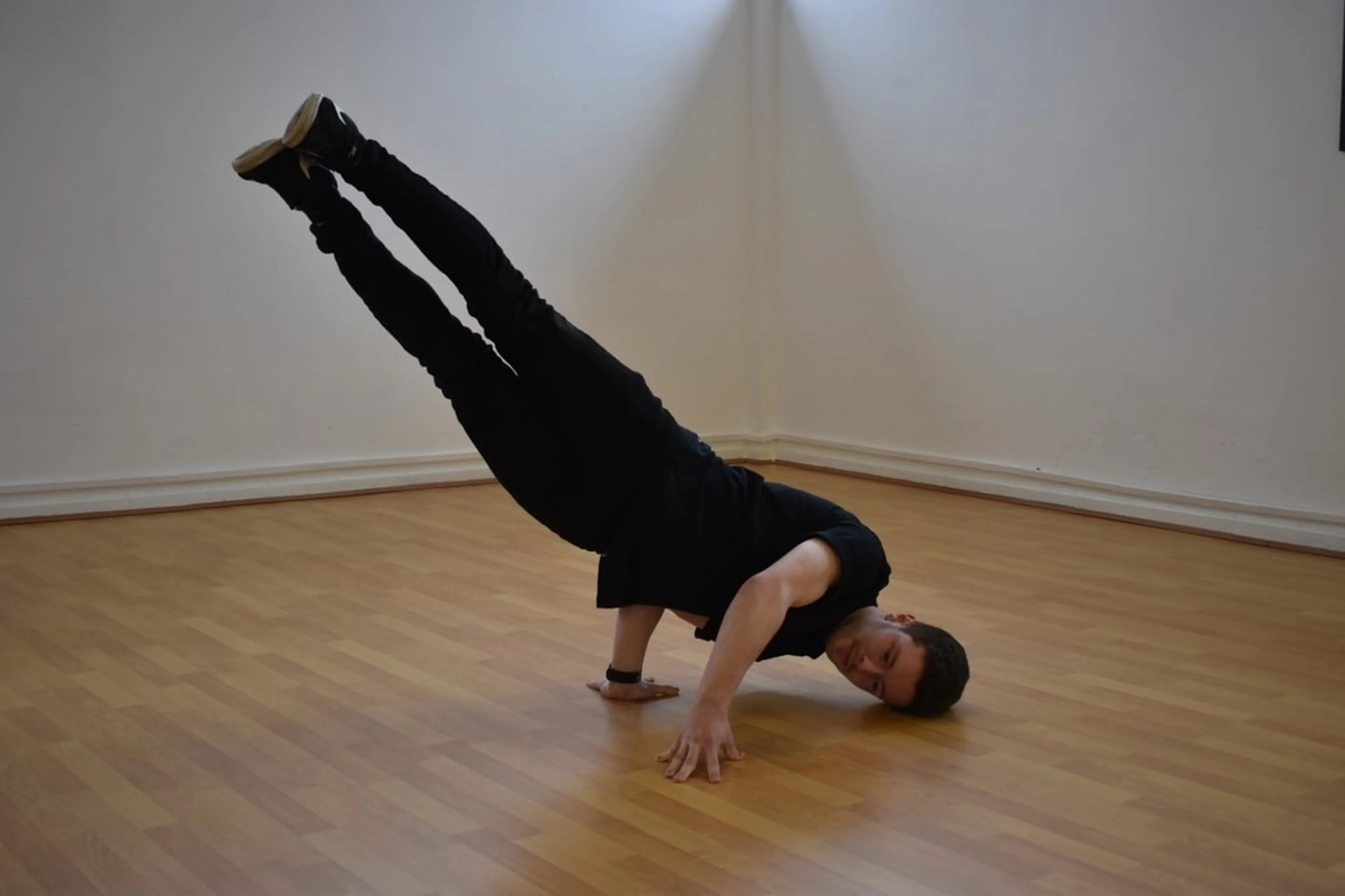 Man spinning on his head in the dance studio